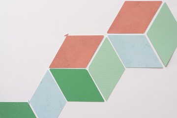 diamond shaped paper pieces arranged in an illusionistic 3d pattern on blank paper