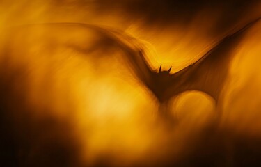Wall Mural - A blurred yellow and dark brown background with soft, out-of-focus light in the shape of bat wings, creating an abstract art effect