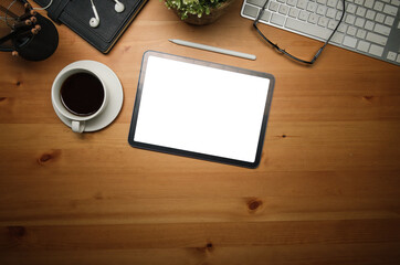 Poster - Top view workspace featuring a tablet with a blank screen, a coffee cup, and a keyboard. The natural wood desk.