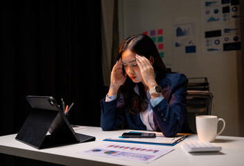 Aufkleber - Stressed asian businesswoman having headache while working late at night in office
