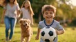 © PirisaTK - Child kicking soccer ball with family and dog in park outdoor activity sunny environment joyful scene