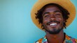 © Lina - A smiling young man wears a colorful floral shirt and a straw hat against a blue background.