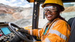 © cs - Smiling female construction worker operating heavy machinery in a mining site with colorful hills