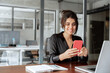© Stock 4 You - Focused Latin Hispanic female businesswoman holding smartphone sitting at desk in office. Successful middle age business woman manager ceo using cell phone mobile pc for online working. Copy space