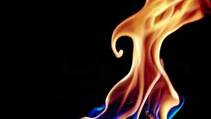 Poster - Dancing flames against a black background with vibrant colors. Energy and warmth concept