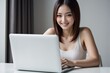 © MF - Smiling Asian woman working on laptop at home, freelance, online business, technology, lifestyle, happy, confident