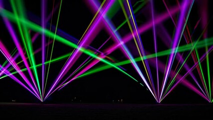 Poster - Colorful laser beams in night sky with vivid hues. Futuristic light show concept