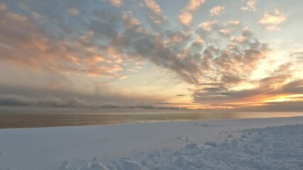 Wall Mural - early morning sunrise over snowy beach and winter ocean landscape