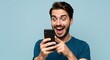 © Muhammad - Excited Man Looking at Phone with Surprised Expression and Pointing