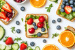 © Gustav - Artistic flat lay of assorted fruit sandwiches on toast, showcasing healthy eating habits and vibrant ingredients for a nutritious lifestyle choice