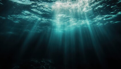 Poster - Serene underwater scene with rays of light penetrating the ocean surface, creating a tranquil and ethereal atmosphere in the deep blue sea