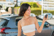 © luismolinero - Young pretty Bulgarian woman holding car keys at outdoors with happy expression