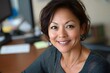 © milkyway - Confident Asian Businesswoman Smiling at in Professional Office Setting