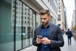 © SimpleDesignStudio - A Focused Caucasian Male in His 30s Discretely Uses His Smartphone While Walking on a Busy City Street Surrounded by Modern Glass Buildings