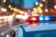 © Arx PhotoStock - Police car lights flashing on city street at night