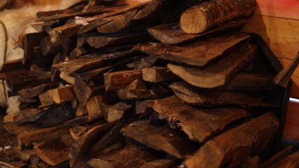 Poster - Two piles of wood and logs sitting side by side.