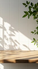 Poster - Sunlight streams through a window, creating intricate shadows on a warm wooden table. Fresh green leaves elegantly frame the scene, enhancing the tranquil atmosphere of the space