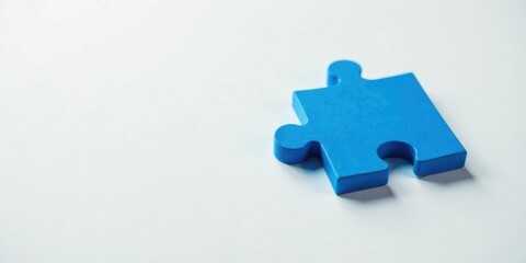 Poster - A Single Blue Jigsaw Piece on a White Surface, Representing Connection, Unity, and the Concept of a Complete Solution