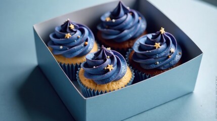 Poster - A delightful assortment of four miniature cakes, adorned with a vibrant purple frosting and star-shaped sprinkles, nestled within a sleek, light blue box.
