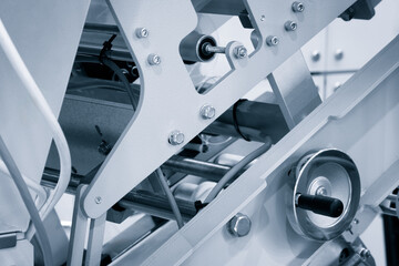 Poster - Automatic polyethylene plastic bag production machine with lighting effect. Close-up of the roller of the plastic bag production machine in the light blue scene. product packaging concept