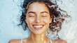 © Coco.Ratta - Smiling Caucasian female closed her eyes joyful in  water droplets suspended around her glowing skin from the waterfall on summer splash water in the pool