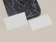 © CreatifyStudio - Business card mockup with shadow effect on marble texture.
