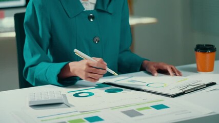 Aufkleber - Professional female executive examining financial documents, tracking data on charts, computing numbers with calculator and pen at workplace workstation