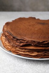 Wall Mural - delicious chocolate crepes on light grey table, closeup