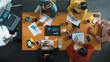 © InfiniteFlow - Top view of smart business man standing while writing and presenting marketing idea at whiteboard. Group of diverse happy people looking at stock market chart and listening presentation. Convocation.