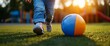 © Bayu - Child Walking Past Ball in Playground