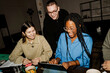 © Maskot - Happy multiracial male and female business professionals working together at tech-start up office