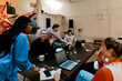 © Maskot - Group of male and female business professionals working together at tech-start up office