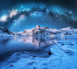 Wall Mural - milky way arch above fjord and snowy mountains on starry winter night. lofoten islands, norway. pano