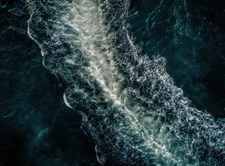 Poster - Serene Aerial View of Turbulent Ocean Waves Creating Beautiful Patterns in Deep Blue Water with Sunlight Reflections and Foamy White Crests