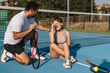 © Addy - Young couple playing tennis outdoors enjoying a fun summer game