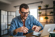 © Miljan Živković - businessman wear eyeglasses and have contactless payment on cellphone