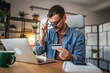 © Miljan Živković - exhausted and tired businessman buy online on laptop and credit card