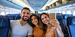 © Andres Mejia - Happy friends taking selfie on airplane during flight