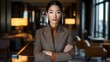 © NAIMAH - Confident businesswoman lobby portrait, arms crossed, hotel background