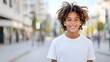 © thanarak - Relaxed and Carefree Mixed Race Teenage Boy with Bright Sunny Smile Posing in Urban Outdoor Setting on City Street