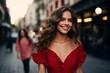 © photolas - A beautiful dark-haired girl with dark hair in a red summer dress walks along the streets of the city. Fashionable romantic look.