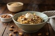 © Dinara - Warm and comforting bowl of oatmeal topped with yogurt, nuts, and a sprinkle of spice in a cozy kitchen setting. Generative AI