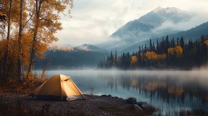 Aufkleber - A yellow camping tent beside a misty lakeside, framed by autumn trees and mountains in the distance, capturing the beauty of nature during a foggy morning