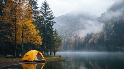 Poster - A yellow tent by the tranquil lakeside with autumn trees and fog rolling over the mountains, creating a picturesque camping scene in a peaceful natural setting