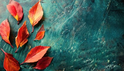 Poster - vibrant autumn leaves on textured dark teal background, artistic seasonal composition for elegant designs and atmospheric decor

