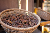 Traditional spices market. Pots and wooden tubs stand with star anise spice. Street bazaar. Dubai, UAE