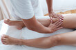 © Westend61 - Osteopath massaging knee joints of patient in treatment room