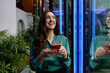 © Westend61 - Smiling entrepreneur in a modern office lobby holding a phone