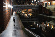© Westend61 - Woman standing by the canal at night in Birmingham