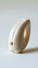 Poster - Elegant ivory plastic ring with geometric pattern on a light background creating a modern aesthetic and minimalist style capturing a clean and simple design